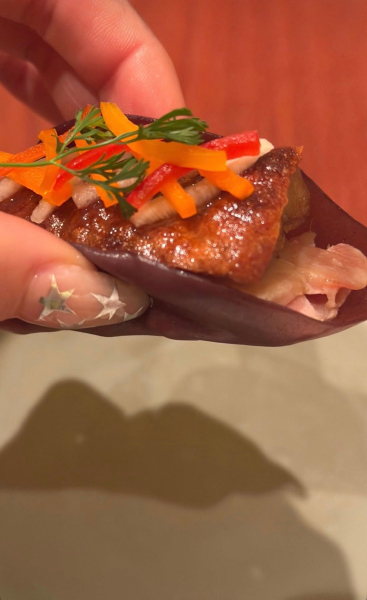 Dua Lipa holding food with a star manicure